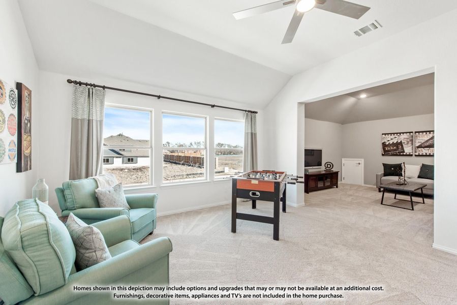 Game room with vaulted ceiling, foosball table, and open layout connecting to a media room with carpet floors. Game room with vaulted ceiling, foosball table, and open layout connecting to a media room with carpet floors.