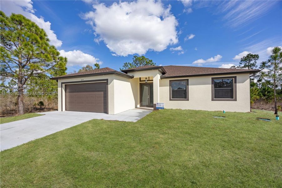 Front exterior of a new home in , Lehigh Acres, FL, highlighting curb appeal (Image 18).