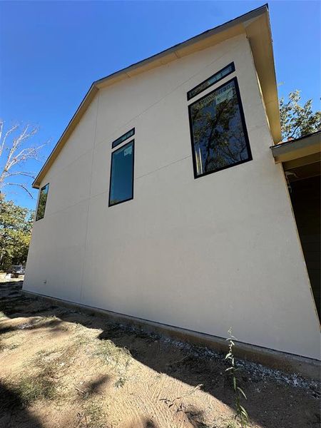 View of property exterior with stucco siding View of property exterior with stucco siding