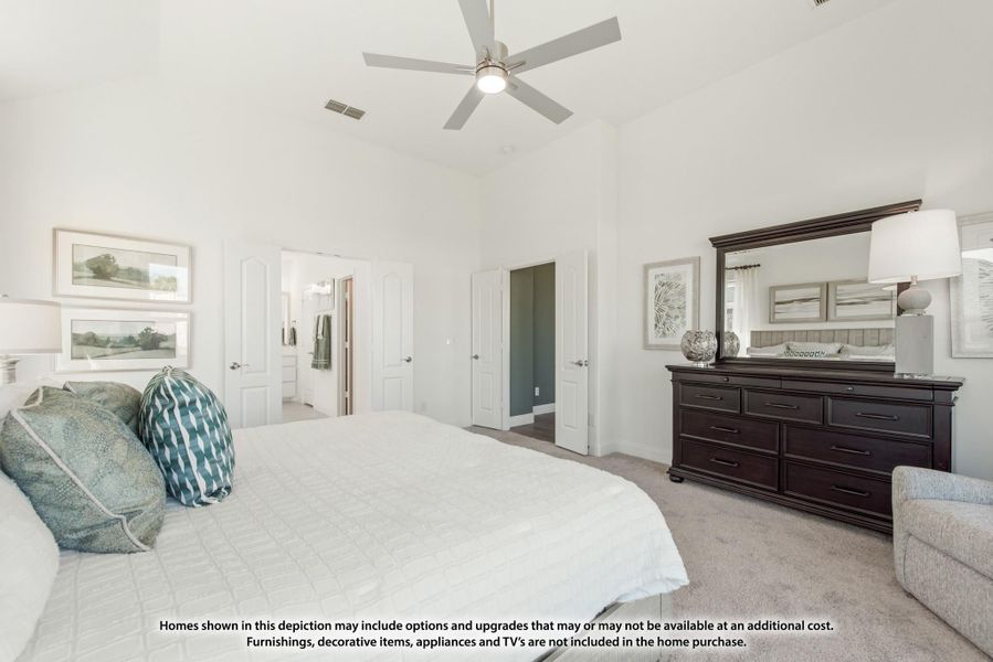 Master bedroom with high ceilings, ceiling fan, dark wood dresser, and doors leading to bathroom and closet Master bedroom with high ceilings, ceiling fan, dark wood dresser, and doors leading to bathroom and closet