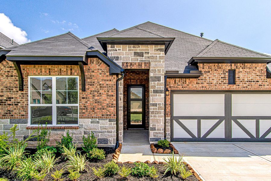 A charming brick and stone exterior, inviting front entry, and attractive architectural details create a warm first impression A charming brick and stone exterior, inviting front entry, and attractive architectural details create a warm first impression