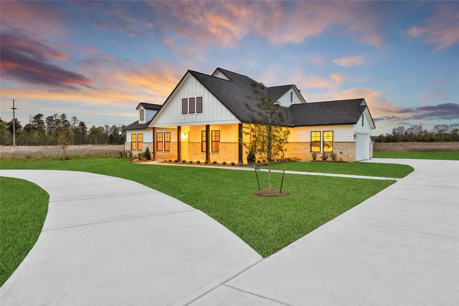 Front exterior of a new home in High Meadow Estates, New Waverly, TX, highlighting curb appeal (Image 26).