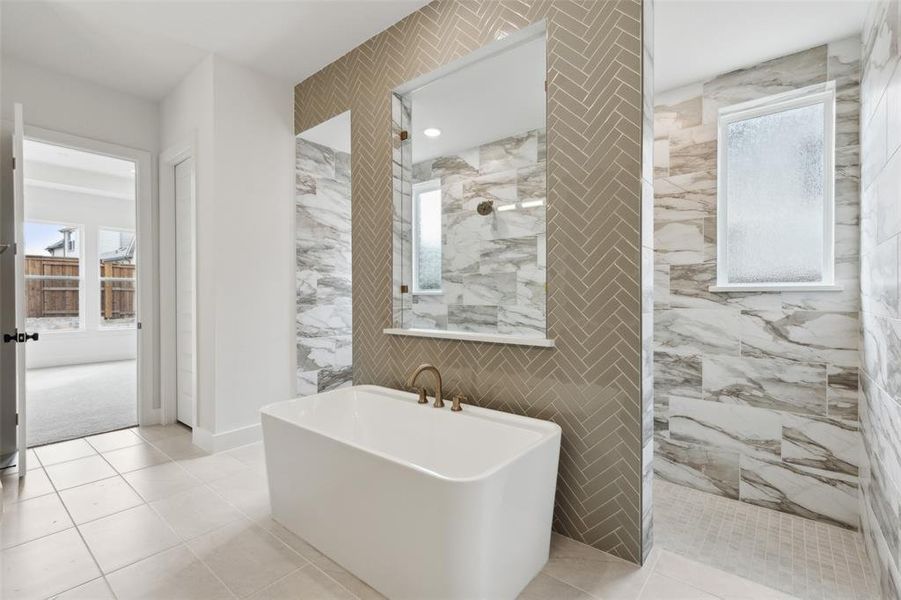 You'll find our signature bath featuring a free standing tub and walk through shower in this dream owner's bath!