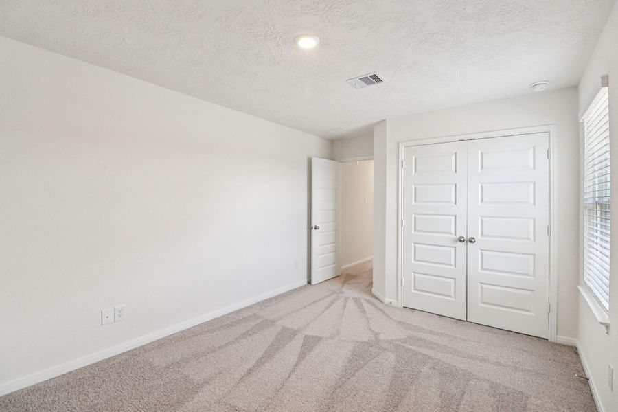 View from secondary bedroom into hallway.