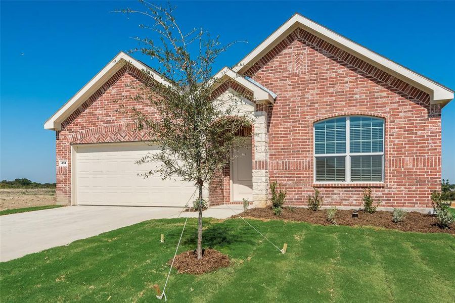 View of property with a front yard and a garage