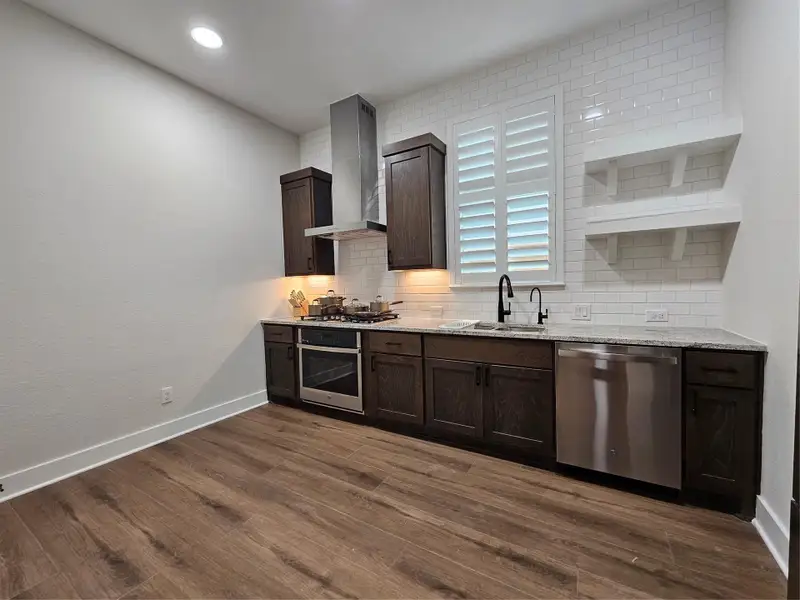 Secondary kitchen equipped with a ventilation system to keep the rest of the home odor-free.