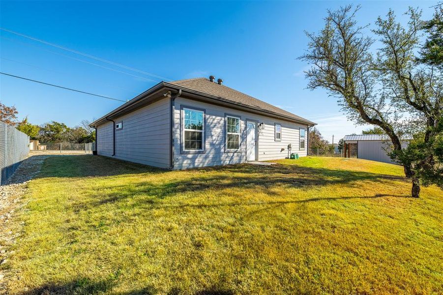 Rear view of house with a lawn