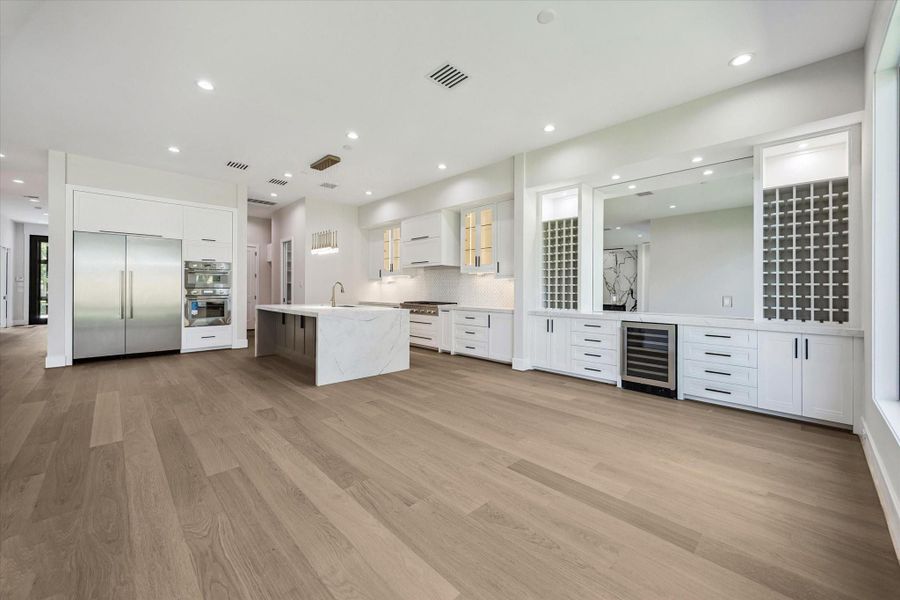 Illuminated display cabinets, subtle under-cabinet lighting, and refined design details showcase exceptional craftsmanship. Premium Thermador appliances elevate the kitchen, including a professional-grade gas range, dishwasher and microwave, blending high performance with modern luxury. Illuminated display cabinets, subtle under-cabinet lighting, and refined design details showcase exceptional craftsmanship. Premium Thermador appliances elevate the kitchen, including a professional-grade gas range, dishwasher and microwave, blending high performance with modern luxury.