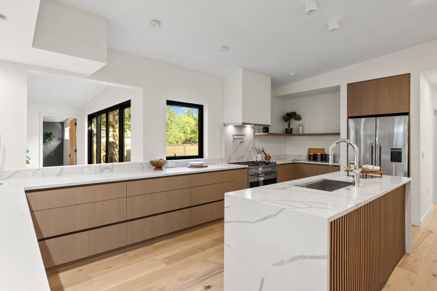 A culinary kitchen with expansive countertops and central island with an under mount sink A culinary kitchen with expansive countertops and central island with an under mount sink