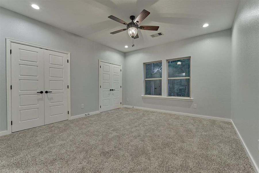 Another guest bedroom on the second floor with window overlooking the back yard.