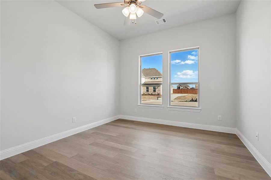Unfurnished room featuring a ceiling fan and light wood-style flooring