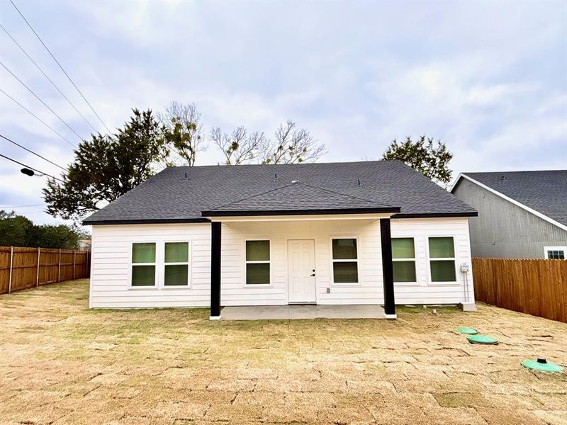 Back of property featuring a lawn and a patio area