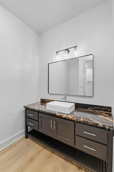 Bathroom featuring vanity and light wood-style floors Bathroom featuring vanity and light wood-style floors