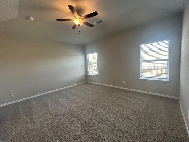 Unfurnished room with a ceiling fan and carpet flooring Unfurnished room with a ceiling fan and carpet flooring