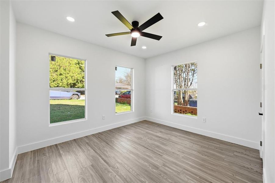 Unfurnished room featuring light wood finished floors, recessed lighting, and a ceiling fan Unfurnished room featuring light wood finished floors, recessed lighting, and a ceiling fan
