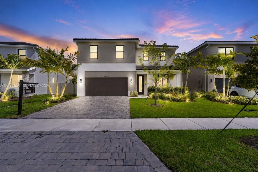 Front exterior of a new home in Parker Pointe, Homestead, FL, highlighting curb appeal (Image 23). Front exterior of a new home in Parker Pointe, Homestead, FL, highlighting curb appeal (Image 23).