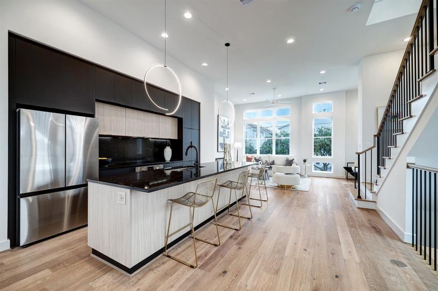 Photos are of 1502 A Ennis, the staged model at Linear on Bell. Choose from two design packages and floor plans. Swoon worthy ultra modern kitchen and pendants.