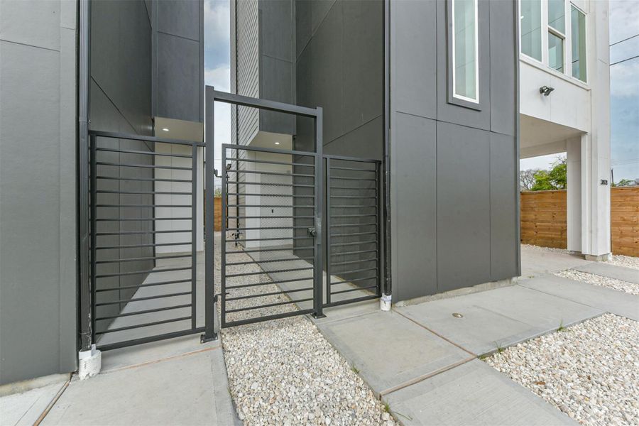 Front door entry is secured by a locked gate.