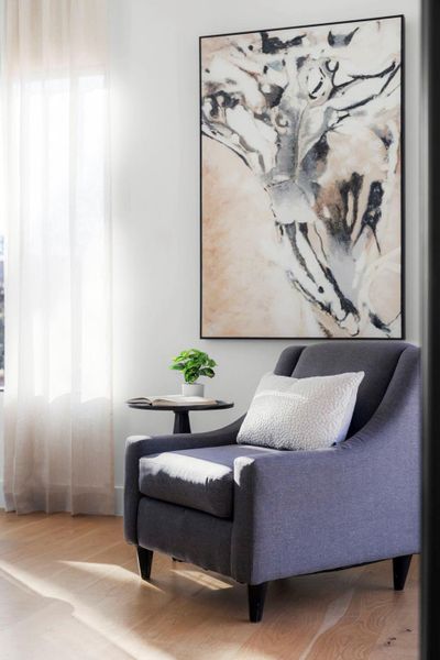 Sitting room with light wood-style floors and healthy amount of natural light