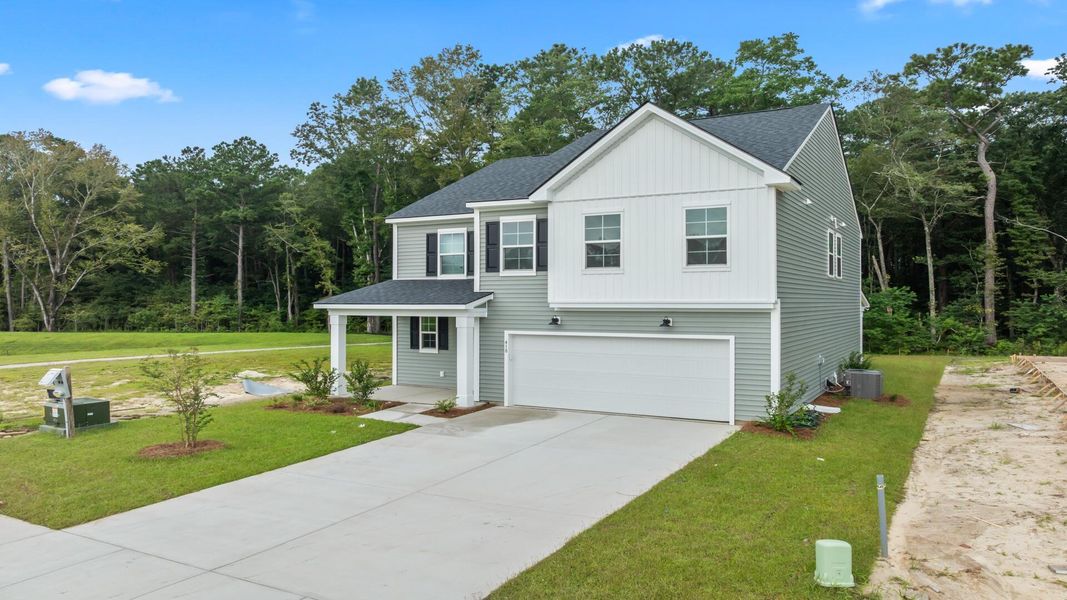 Front exterior of a new home in Creekside at Andrews, Summerville, SC, highlighting curb appeal (Image 1).