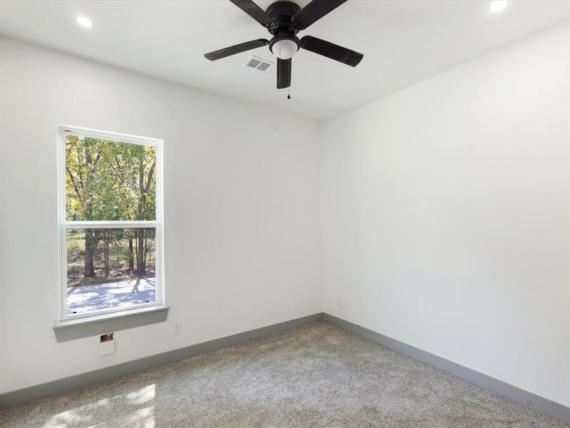 Carpeted empty room with recessed lighting and ceiling fan Carpeted empty room with recessed lighting and ceiling fan