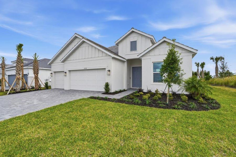 Front exterior of a new home in Coasterra Community Group Page, Palmetto, FL, highlighting curb appeal (Image 20).