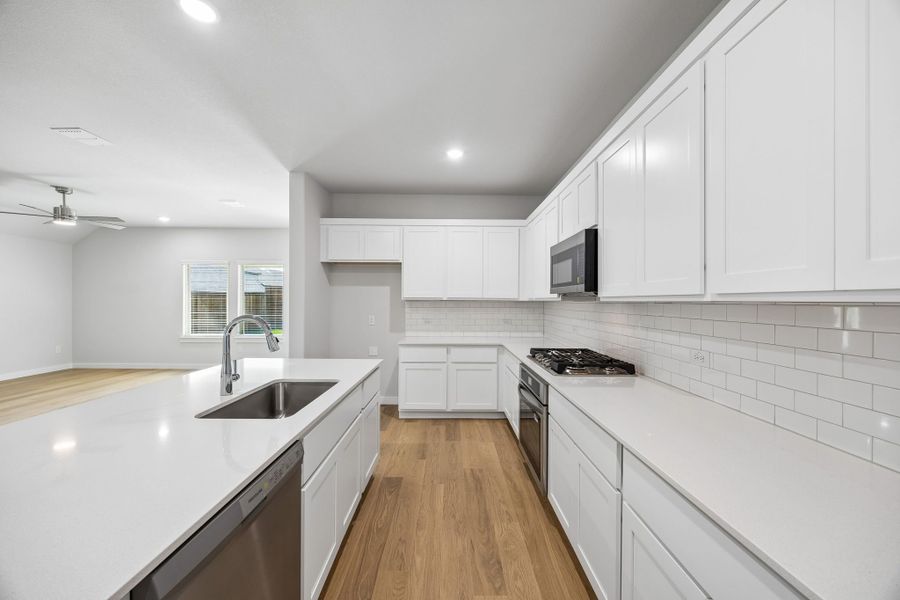 Kitchen in the Oscar home plan by Trophy Signature Homes – REPRESENTATIVE PHOTO