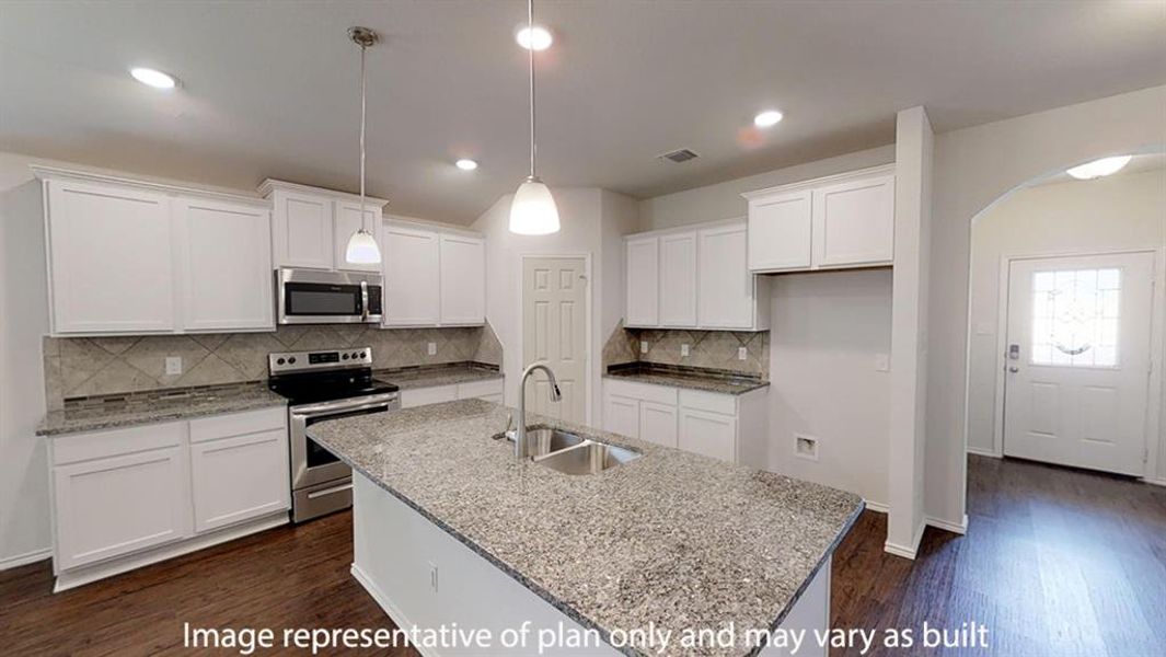 Kitchen featuring dark wood finished floors, stainless steel appliances, white cabinets, arched walkways, and light stone countertops Kitchen featuring dark wood finished floors, stainless steel appliances, white cabinets, arched walkways, and light stone countertops