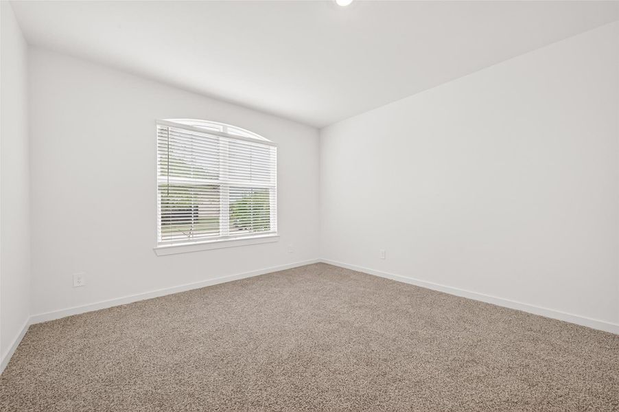 Downstairs Guest Bedroom: A private guest bedroom at the front of the home includes plush carpet, a walk-in closet, and convenient access to a private full bathroom.