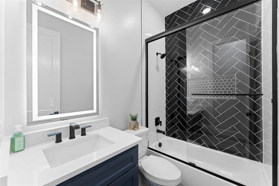 Bathroom featuring vanity and enclosed tub / shower combo Bathroom featuring vanity and enclosed tub / shower combo