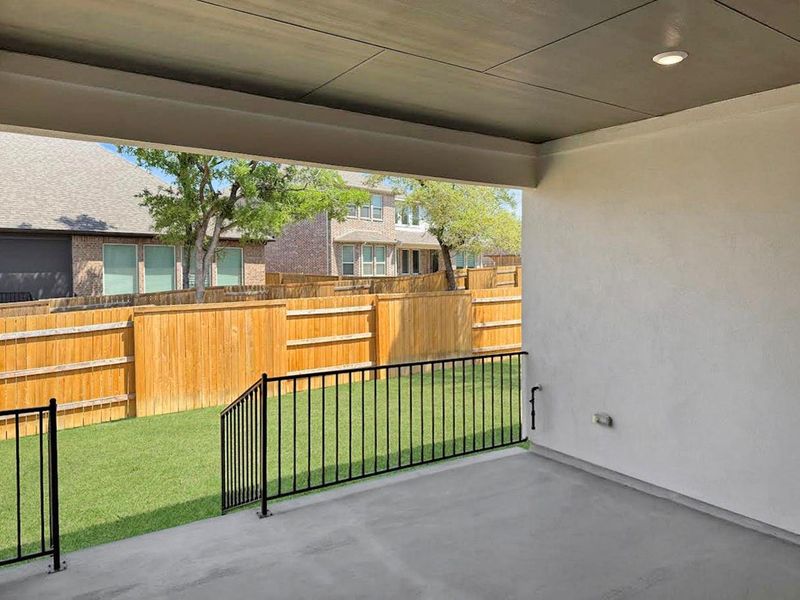Fenced backyard with a patio area