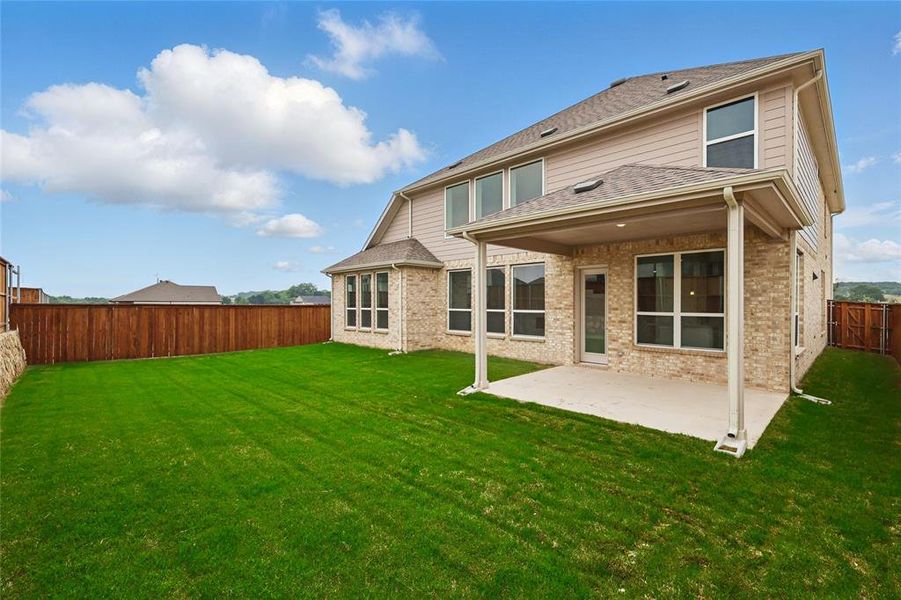 Rear view of house with a patio and brick siding Rear view of house with a patio and brick siding