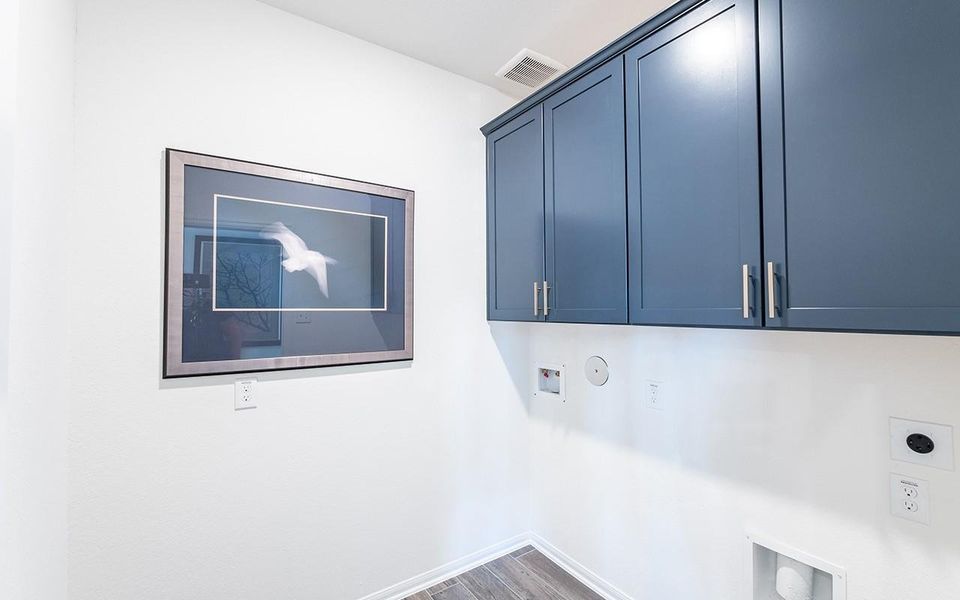 Laundry area with hookup for an electric dryer, cabinet space, hookup for a washing machine, hookup for a gas dryer, and wood finished floors Laundry area with hookup for an electric dryer, cabinet space, hookup for a washing machine, hookup for a gas dryer, and wood finished floors