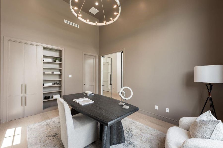 A thoughtfully designed flex space that balances form and function, featuring custom built-in shelving and concealed storage for a clean, tailored look. Soft neutral tones and natural light create a calm backdrop—ideal for a home office, reading lounge, or quiet retreat.