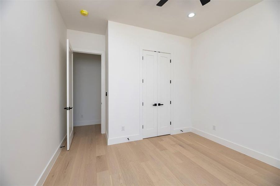 Unfurnished bedroom with light wood finished floors, recessed lighting, a closet, and ceiling fan Unfurnished bedroom with light wood finished floors, recessed lighting, a closet, and ceiling fan