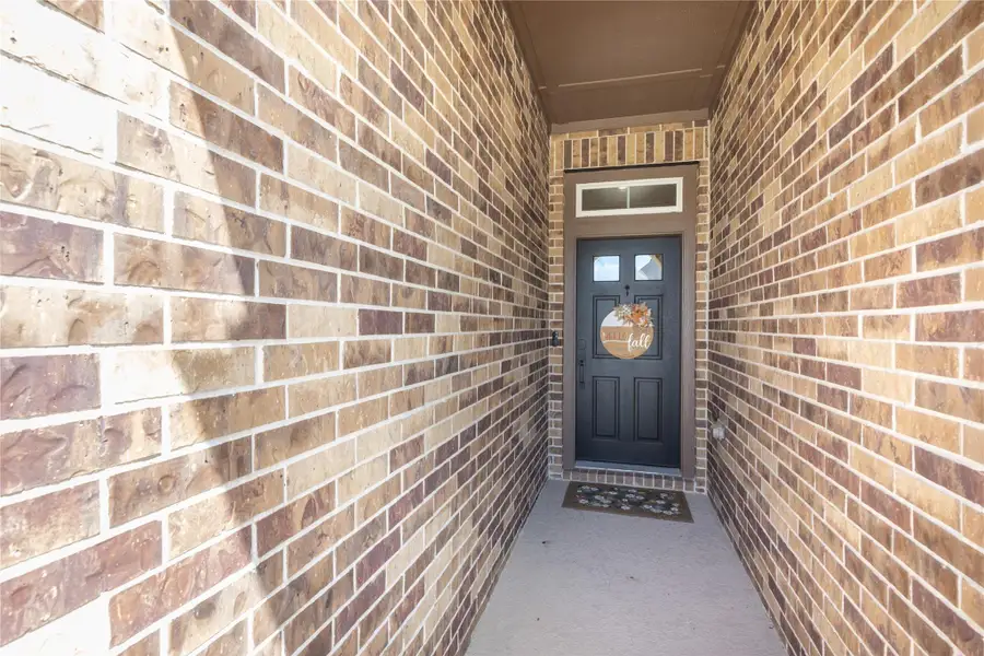 Entryway with a warm brick facade and a welcoming front door, perfect for greeting guests.