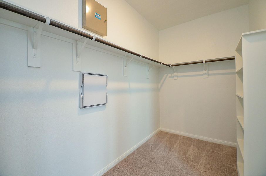 Step into this spacious closet with built-in shelving, perfect for storage. Step into this spacious closet with built-in shelving, perfect for storage.