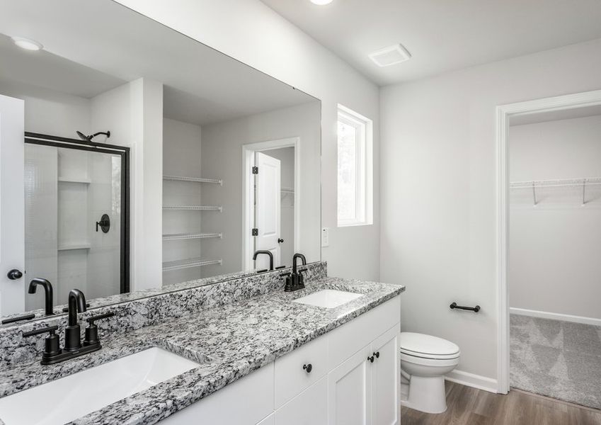 The master bathroom features dual-vanity sinks. The master bathroom features dual-vanity sinks.