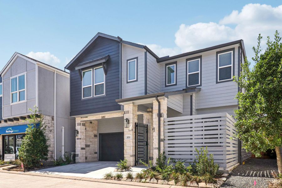 Front exterior of a new home in Spring Brook Village - Luxe Series, Houston, TX, highlighting curb appeal (Image 1). Front exterior of a new home in Spring Brook Village - Luxe Series, Houston, TX, highlighting curb appeal (Image 1).