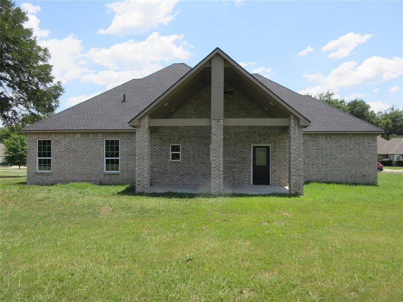 Back of house featuring a lawn