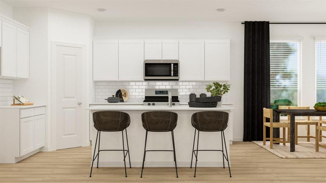 Kitchen featuring appliances with stainless steel finishes, light hardwood / wood-style floors, and white cabinets