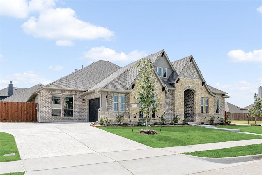 Front exterior of a new home in Ridgepoint, Midlothian, TX, highlighting curb appeal (Image 1).