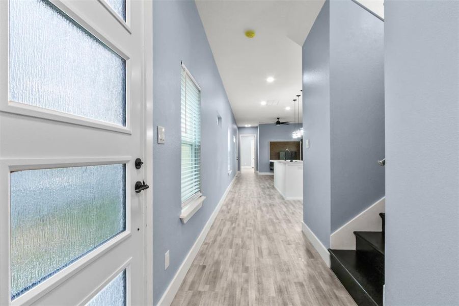 Hallway featuring light hardwood / wood-style flooring and plenty of natural light