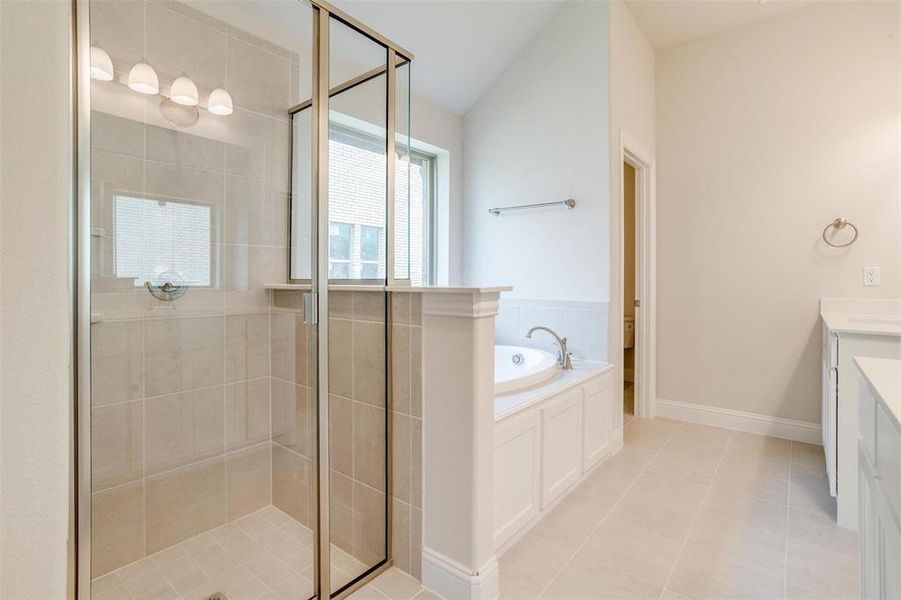 Bathroom featuring vanity, separate shower and tub, and tile patterned flooring