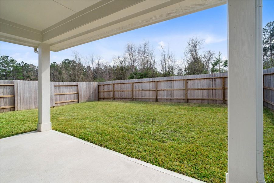 The spacious covered patio offers a tranquil outdoor retreat, perfectly designed for savoring your quiet morning coffee or unwinding during peaceful evening relaxation.