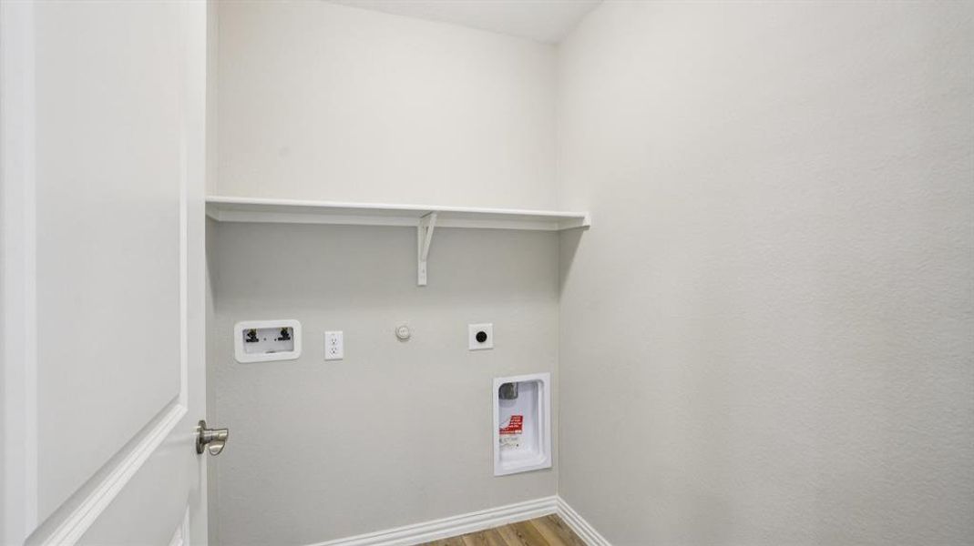 Washroom with hookup for a gas dryer, light wood-style flooring, washer hookup, and electric dryer hookup Washroom with hookup for a gas dryer, light wood-style flooring, washer hookup, and electric dryer hookup