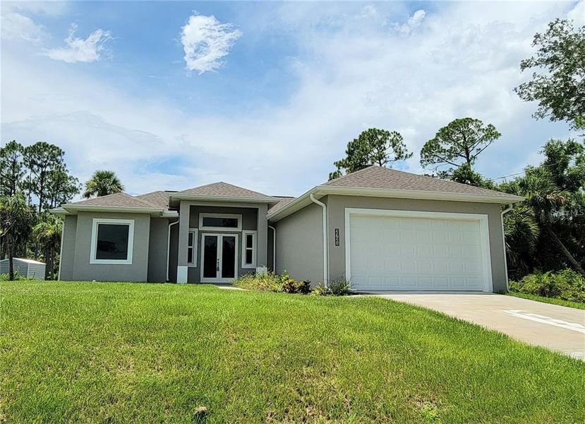 Front exterior of a new home in , North Port, FL, highlighting curb appeal (Image 1). Front exterior of a new home in , North Port, FL, highlighting curb appeal (Image 1).