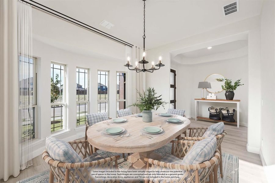 Dining room with round wood table, wicker chairs, black chandelier, and large windows with white curtains