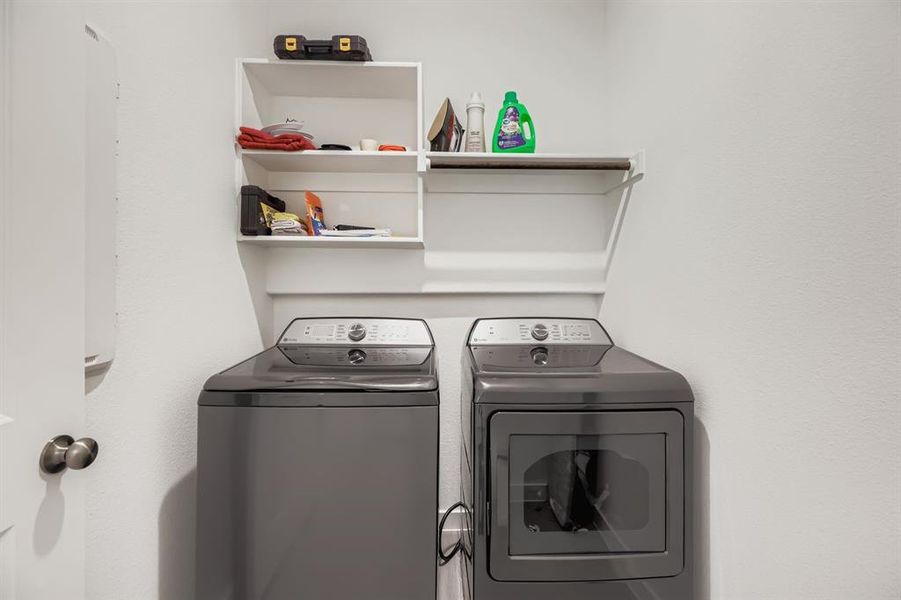 Laundry room with washing machine and clothes dryer