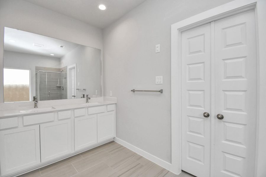 Elevate your daily routine at the elegant vanity, now equipped with double sinks, light countertops, modern hardware, and beautiful recessed lights. Elevate your daily routine at the elegant vanity, now equipped with double sinks, light countertops, modern hardware, and beautiful recessed lights.